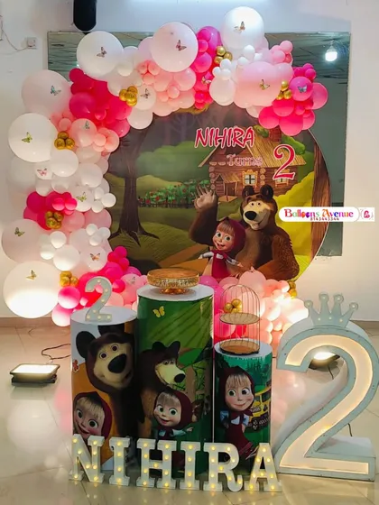 A fun and adventurous Masha and the Bear themed party for Nihira's second birthday. The decorations feature a forest backdrop and props with the beloved characters.