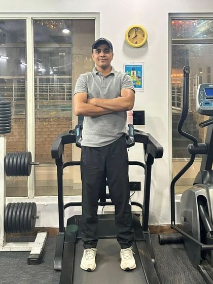 Posing on the treadmill in a home gym.