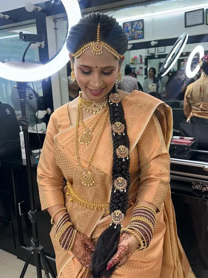 A full view of the traditional hairstyle, showing the neatness of the braid and the placement of the accessories.