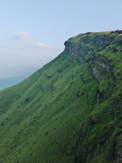 A stunning view of a peak in Chikmagalur on a clear day.