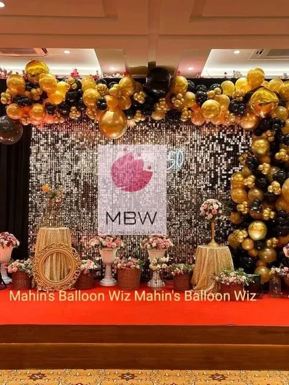 Celebrating a 60th anniversary is a monumental occasion. I designed this glamorous stage with a gold and black balloon arch over a dazzling shimmer wall, complete with floral arrangements and marquee lighting, to honor the couple's incredible journey.