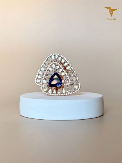 I love turning shapes into statements. This ring features a striking triangular tanzanite gemstone, surrounded by a fan of diamonds that sparkles from every angle.