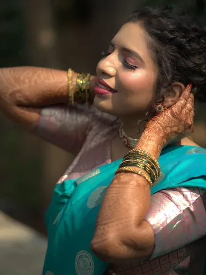 The bride showing off her intricate mehndi design, her makeup looking flawless.