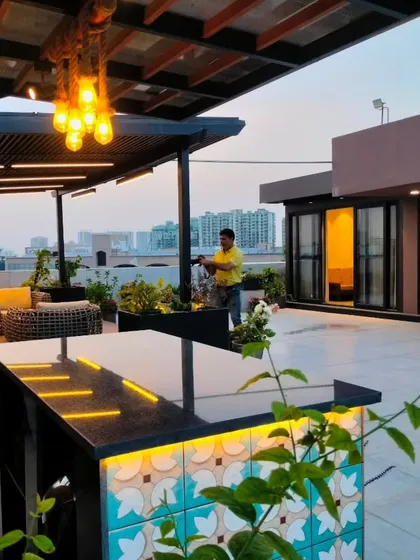 This angle shows the bar's placement on the terrace, with a high-top table for enjoying drinks with a view.
