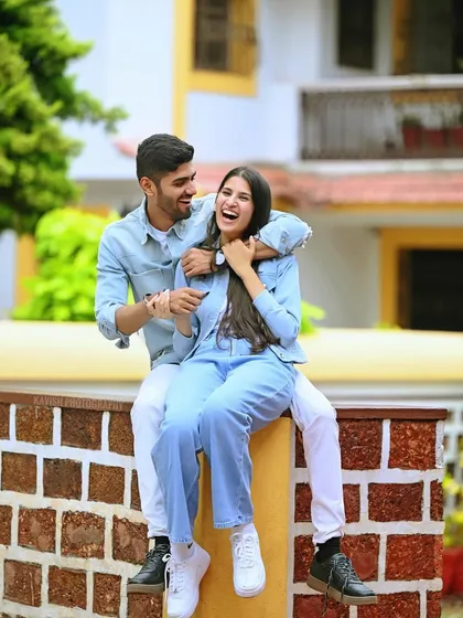 A joyful, candid moment from a pre-wedding shoot, capturing genuine laughter and connection.