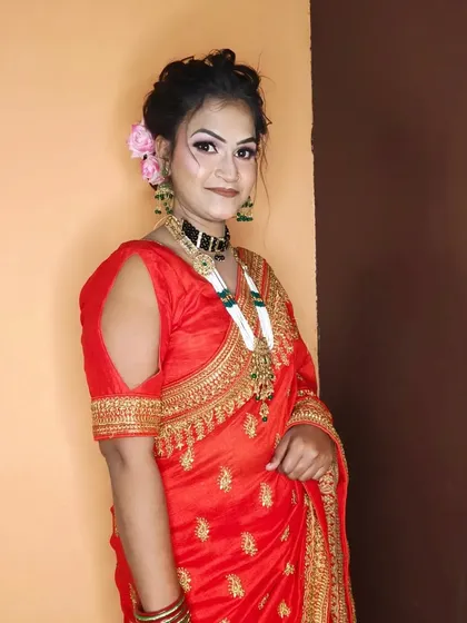 A full-length shot of the client in her beautiful red embroidered saree.