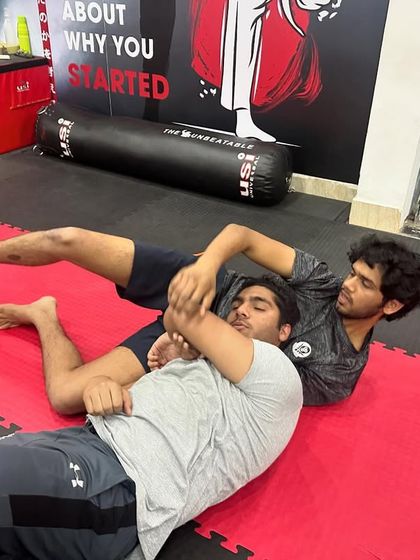 A student practices an armbar submission from the mount position. We teach the mechanics of BJJ submissions step-by-step to ensure safety and proper technique.