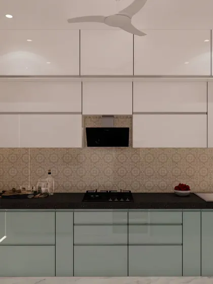 A straight-line view of the blue and ivory kitchen, showing the patterned backsplash and the sleek, integrated chimney. The handleless design maintains a clean and modern aesthetic.