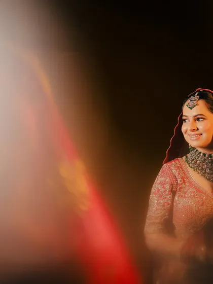 An artistic shot using a prism effect to create a beautiful light flare, adding a touch of magic to this smiling bride's portrait.