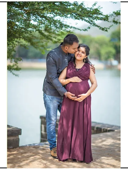 A sweet kiss on the cheek, capturing a simple, loving moment by the water.