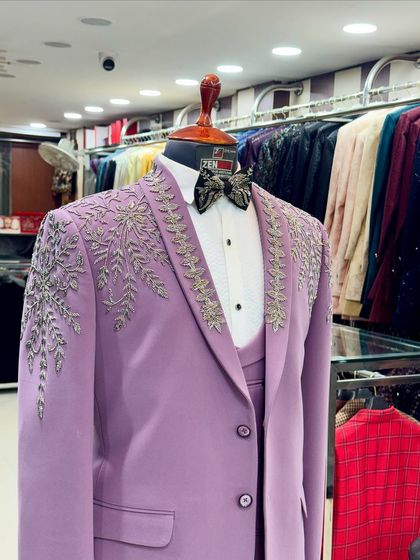 A different angle of the lavender tuxedo, highlighting the intricate, leaf-like silver embroidery on the shawl lapel. This piece is a testament to bold color choices in men's formalwear.