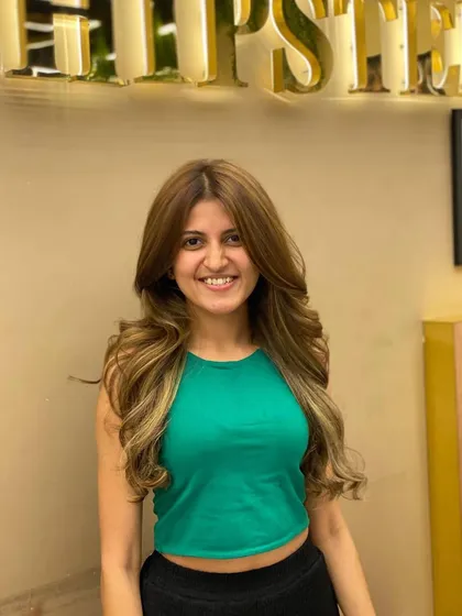 A happy client showing off her new hair color and style, a perfect way to start the new year with confidence.