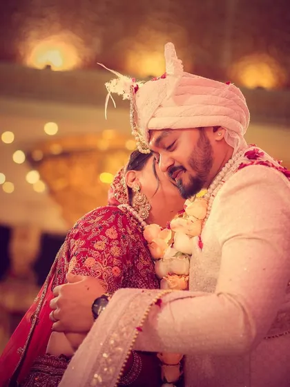 An emotional and tender hug between the bride and groom right after the varmala exchange.