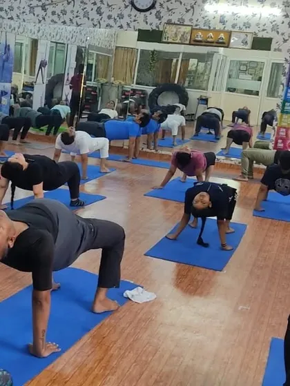 The class moves together into Purvottanasana, or the Reverse Plank Pose. This is a great posture for strengthening the arms, wrists, and back, while also opening up the chest.