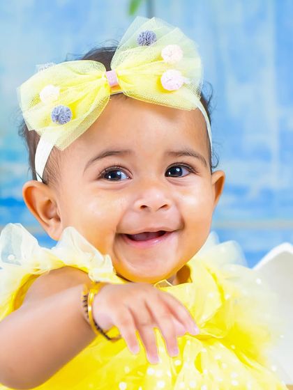 The happiest little chick. A close-up shot capturing the infectious smile of the baby in our Easter egg setup.