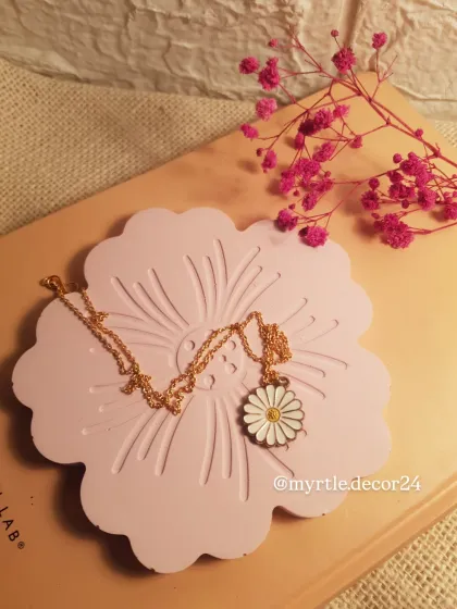 Another view of our pink floral tray, this time holding a beautiful daisy necklace. It's a sweet and simple way to keep your favorite pieces safe.