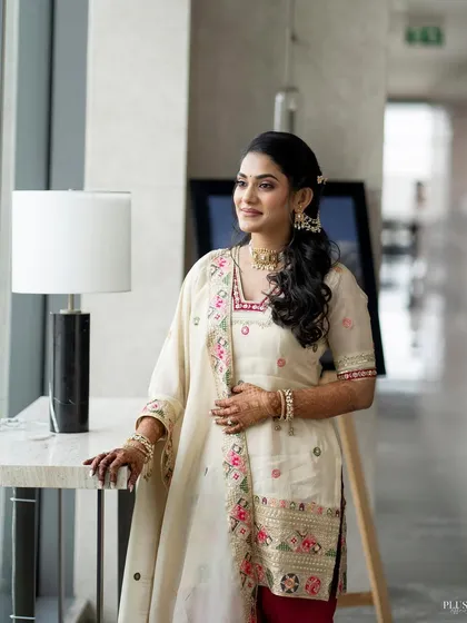 Supriya by the window, with natural light highlighting her fresh and flawless makeup. Perfect for any daytime event.