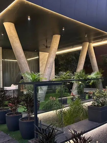 Another angle of the architecturally unique rooftop structure, showing the seamless integration of planters and a glass railing.