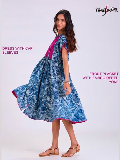 Our Chaaya dress with cap sleeves and an embroidered yoke. The flowing fabric and beautiful indigo print create a piece that moves with you and feels good all day long.