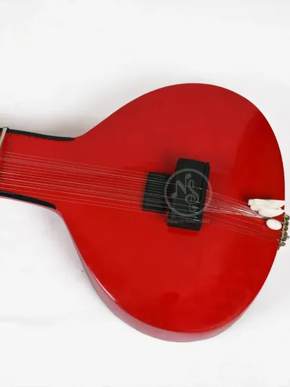 The front of the red Zitar, showing the strings running over the pickup. This direct amplification captures the raw sound of the strings.