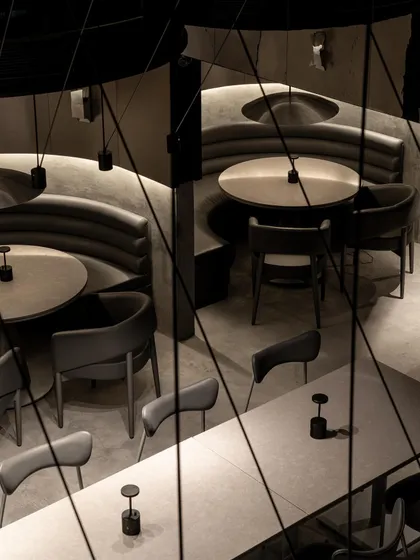 Another aerial perspective, showing the interplay of light and shadow across the different seating arrangements. The design creates a complex tapestry of interconnected yet separate zones.