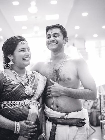 A heartwarming black and white photo of an expectant couple sharing a joyful moment during their traditional baby shower.