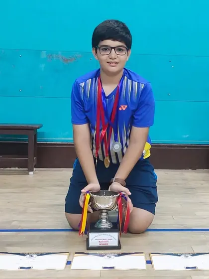 Meherzad Bulsara, a ShuttleCraze trainee, posing with his trophy after winning the U15 Boys Singles and Doubles at The Cushrow Baug Annual Badminton Tournament.