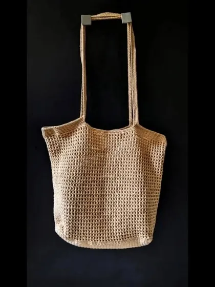 The simple and elegant silhouette of our crochet jhola bag, ready to be taken on the go. We use eco-friendly yarn to create these sustainable fashion pieces.