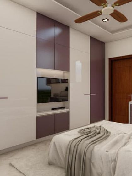 Another angle of the purple and white bedroom, showing the integrated study desk next to the wardrobe.