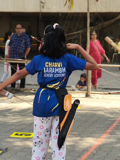 A young girl takes aim, fully concentrated on her target. Our trials are designed to be a positive and encouraging experience for all participants.