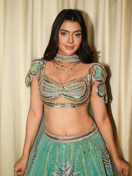 A smiling portrait that shows off the beautiful, soft-focus finish of the makeup. It's a perfect look for a daytime reception or engagement party.