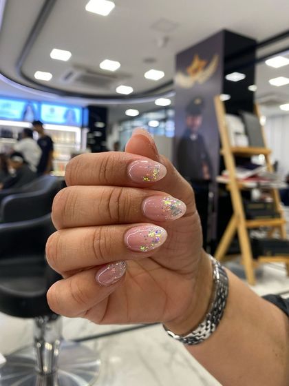 A soft and pretty design with a neutral pink base and a delicate glitter fade effect.