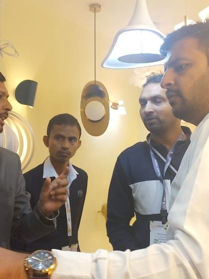 New brands, new products, new ideas. An exhibitor passionately explains his offerings to a potential business partner.