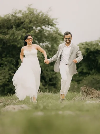 Pure, unfiltered joy. I love capturing these candid moments, like this couple running freely in the fields near Agra. It’s these natural, happy shots that truly tell your story.