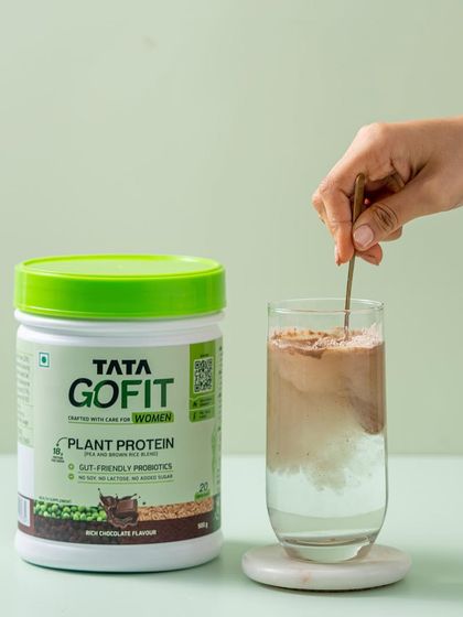 A simple, effective demonstration of the product in use. We show Tata GoFit's plant protein being mixed into a glass of water, highlighting how easily it dissolves.