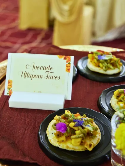A creative take on a South Indian classic. These Avocado Uttapam Tacos are mini uttapams topped with a fresh and zesty avocado mixture, garnished with edible flowers.