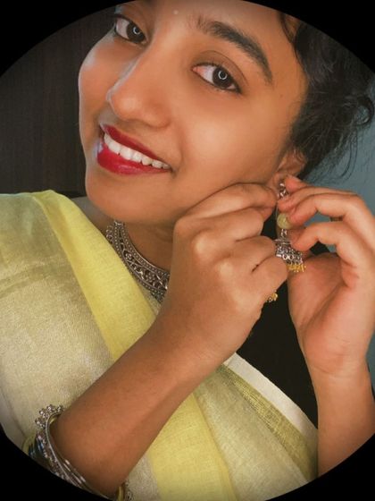 Getting ready is a ritual. Here I am putting on the yellow beaded jhumkas that complete my yellow-themed festive look, paired with a beautiful linen saree.