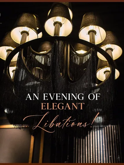 A modern black chandelier with fringe details, an example of the unique lighting fixtures I source to match a specific theme.