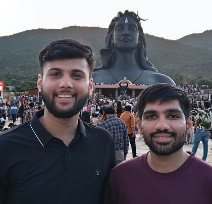 Two friends in front of the Adiyogi statue. It's a popular spot for reflection and photography.