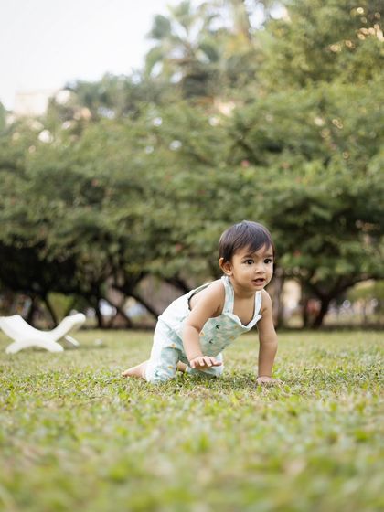 On the move! Capturing the crawling milestone in a beautiful green park.