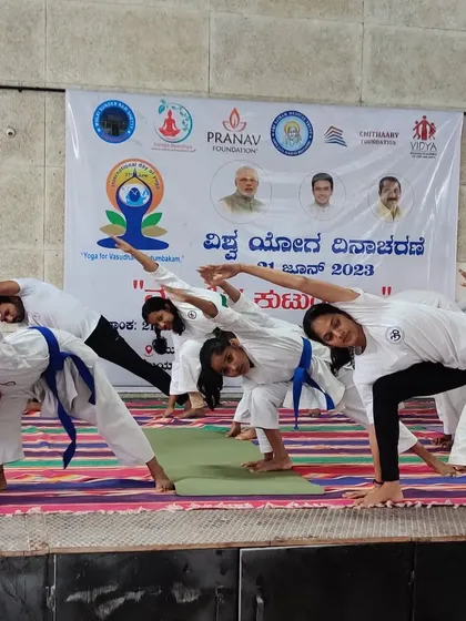 Our students practicing Trikonasana (Triangle Pose) during a yoga session. We integrate yoga and stretching to improve flexibility, balance, and mental focus, which are essential skills for any martial artist.