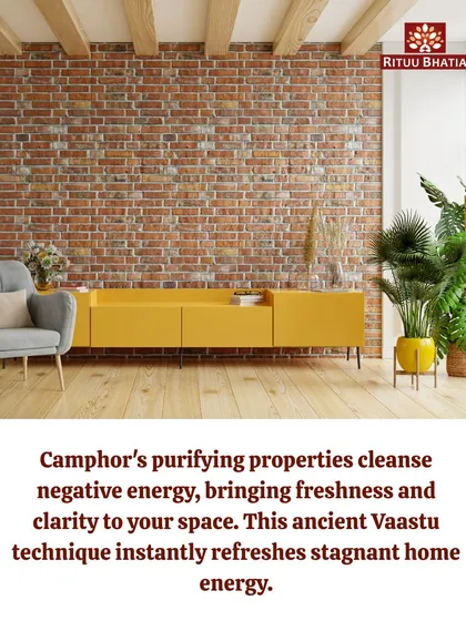 This image of a clean, modern living room with a brick wall highlights how ancient Vaastu techniques can be applied to any home. The purifying properties of camphor can instantly refresh stagnant energy, bringing a sense of clarity and freshness to your space.