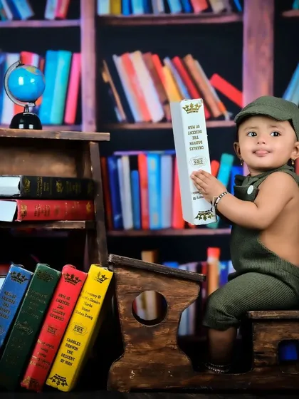 A little scholar in a library setup, looking curious and engaged with the books.