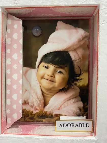 "Adorable." This sweet photo of the baby in a bathrobe is one of the many cherished moments captured in her personalized first-year frame.