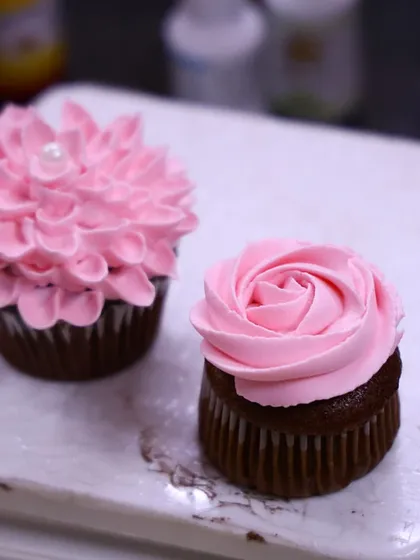 A shot of two beautiful floral cupcakes I created during a workshop at Don Bosco Academy. I love teaching others how to pipe designs like the rose and the dahlia.