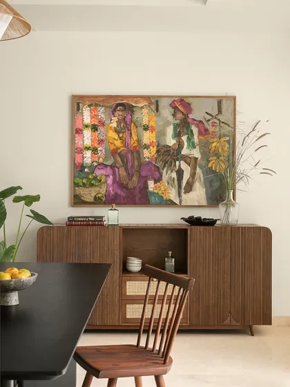 Art is not just decoration; it defines a space. In this dining area, a powerful artwork from JS Mani’s Badami Series becomes the focal point. I designed the custom fluted sideboard and selected the dining furniture to complement the painting's earthy hues and vibrant energy, creating a sophisticated space for gatherings.