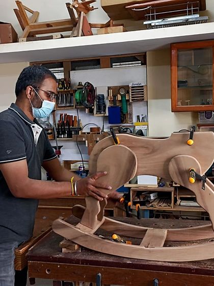 Chetan carefully assembles the rocking horse he is building as a gift for his nephew. It's a project that takes time and patience, but the result is well worth it.