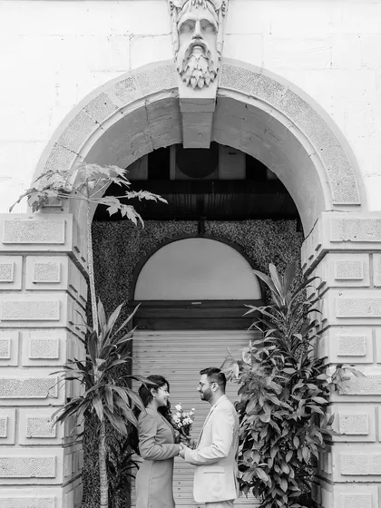 A classic black and white portrait under a beautifully sculpted archway in Mumbai. The symmetry of the architecture perfectly frames the couple, creating an elegant and timeless image.