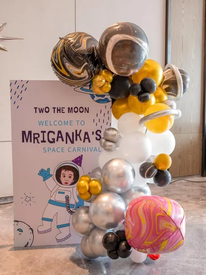 The welcome sign for a 'Space Carnival' birthday party, complete with a custom illustration and a galaxy of balloons.