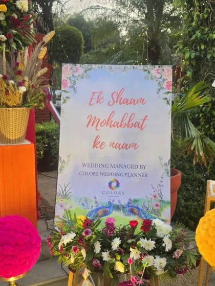 A romantic welcome sign with the phrase 'Ek Shaam Mohabbat ke naam' (An Evening in the Name of Love). Surrounded by floral arrangements, this sign adds a poetic and personal touch to the celebration.